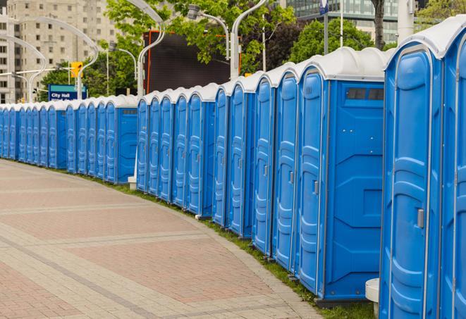 a row of portable restrooms at an outdoor special event, ready for use in Allenwood, NJ